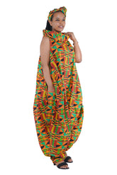 Elegant African woman wearing long high neck jumpsuit with matching headwrap in traditional print – 100% cotton, includes side pockets.