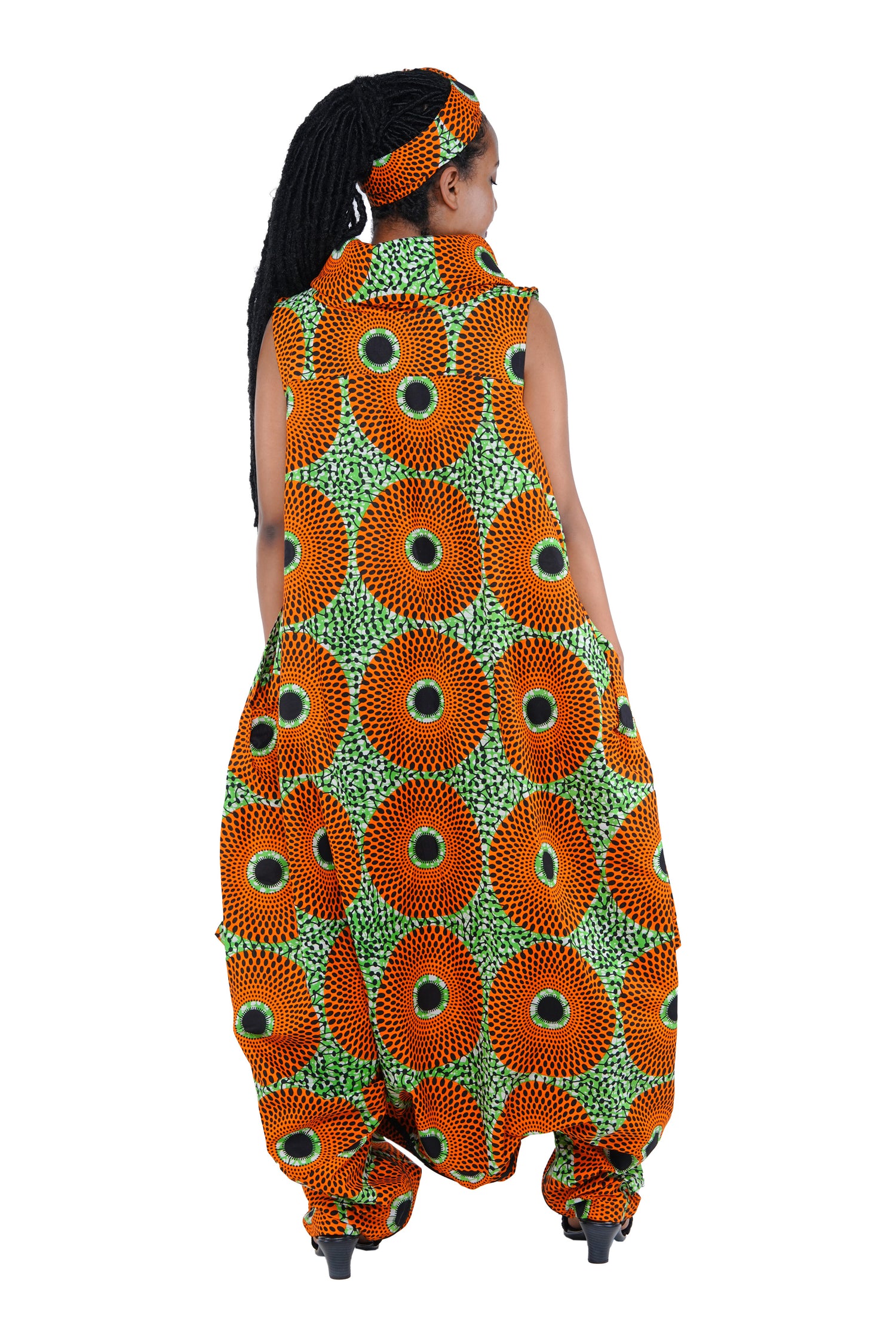 Elegant African woman wearing long high neck jumpsuit with matching headwrap in traditional print – 100% cotton, includes side pockets.