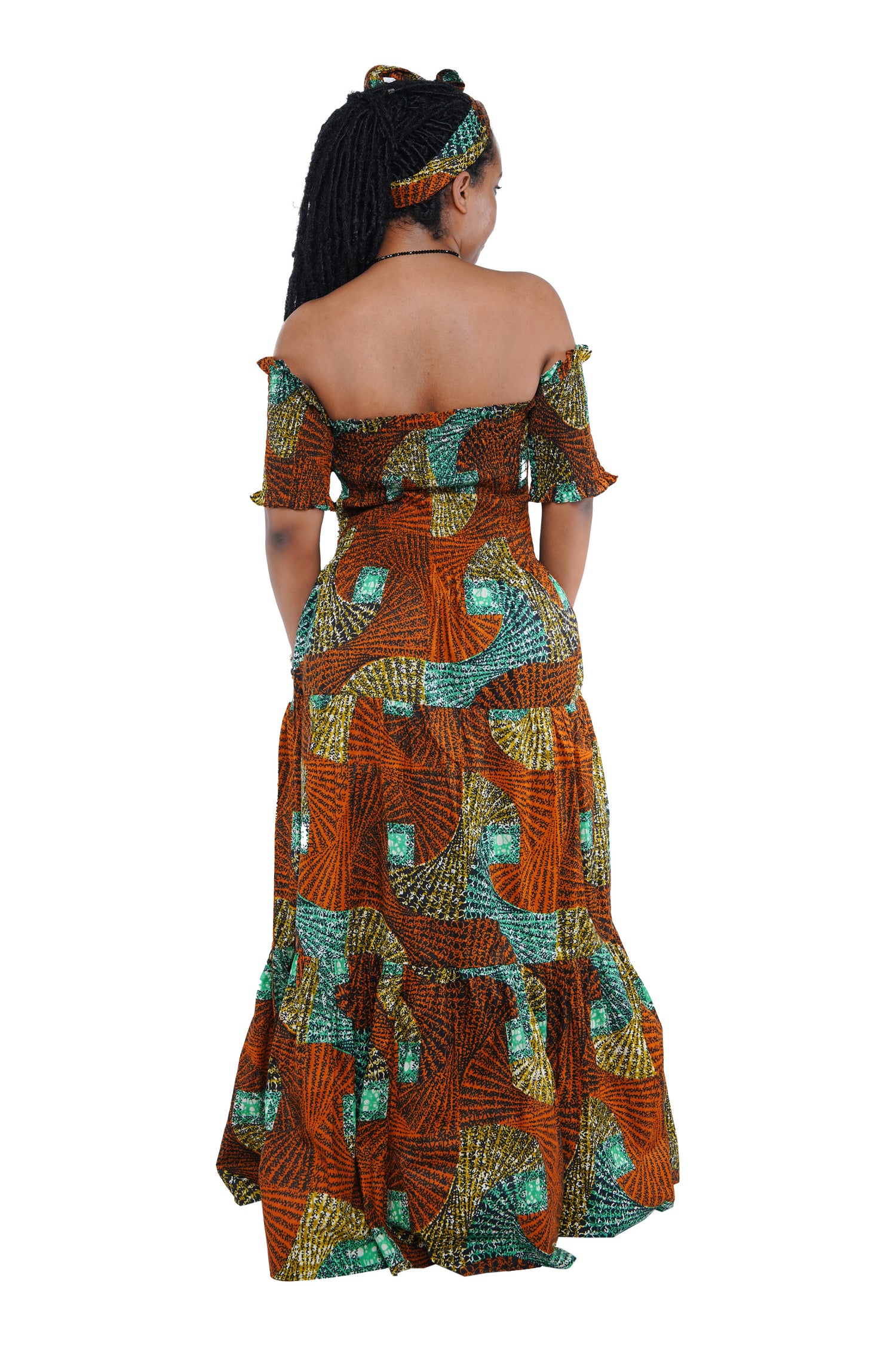 “Back view of smocked bodice off shoulder African print dress”