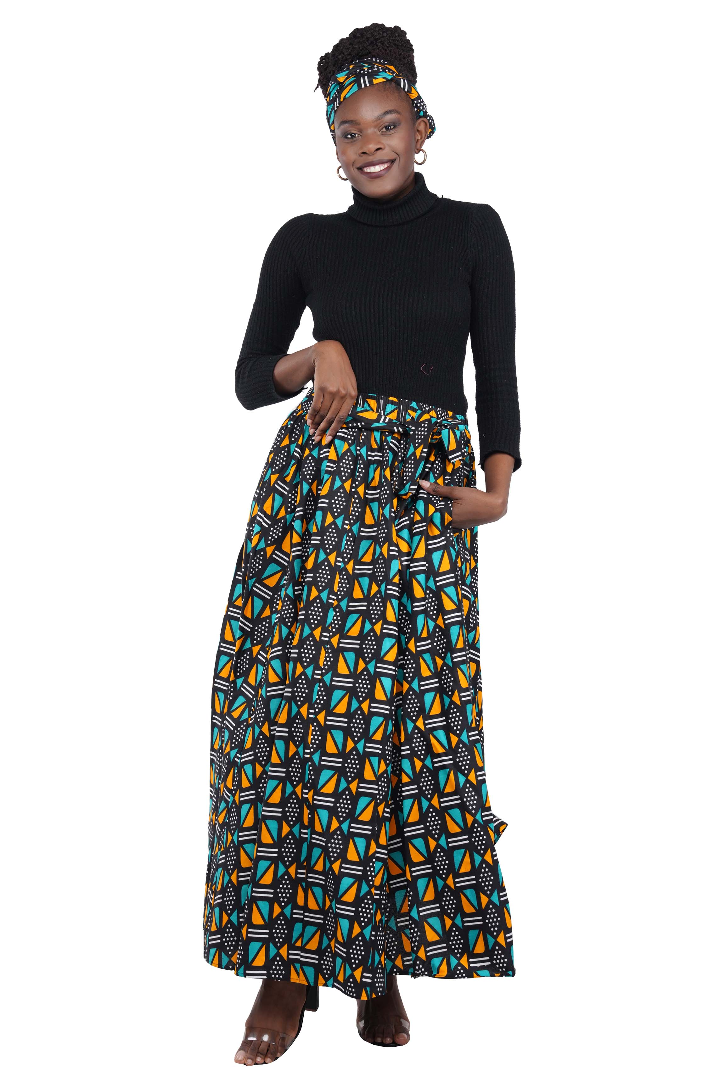Woman wearing African print long maxi skirt in bold Ankara fabric, styled for cultural events, weddings, or everyday elegance.