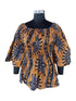 Woman wearing African smocked peplum blouse with 3/4 sleeves in Ankara print