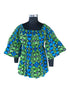 Woman wearing African smocked peplum blouse with 3/4 sleeves in Ankara print