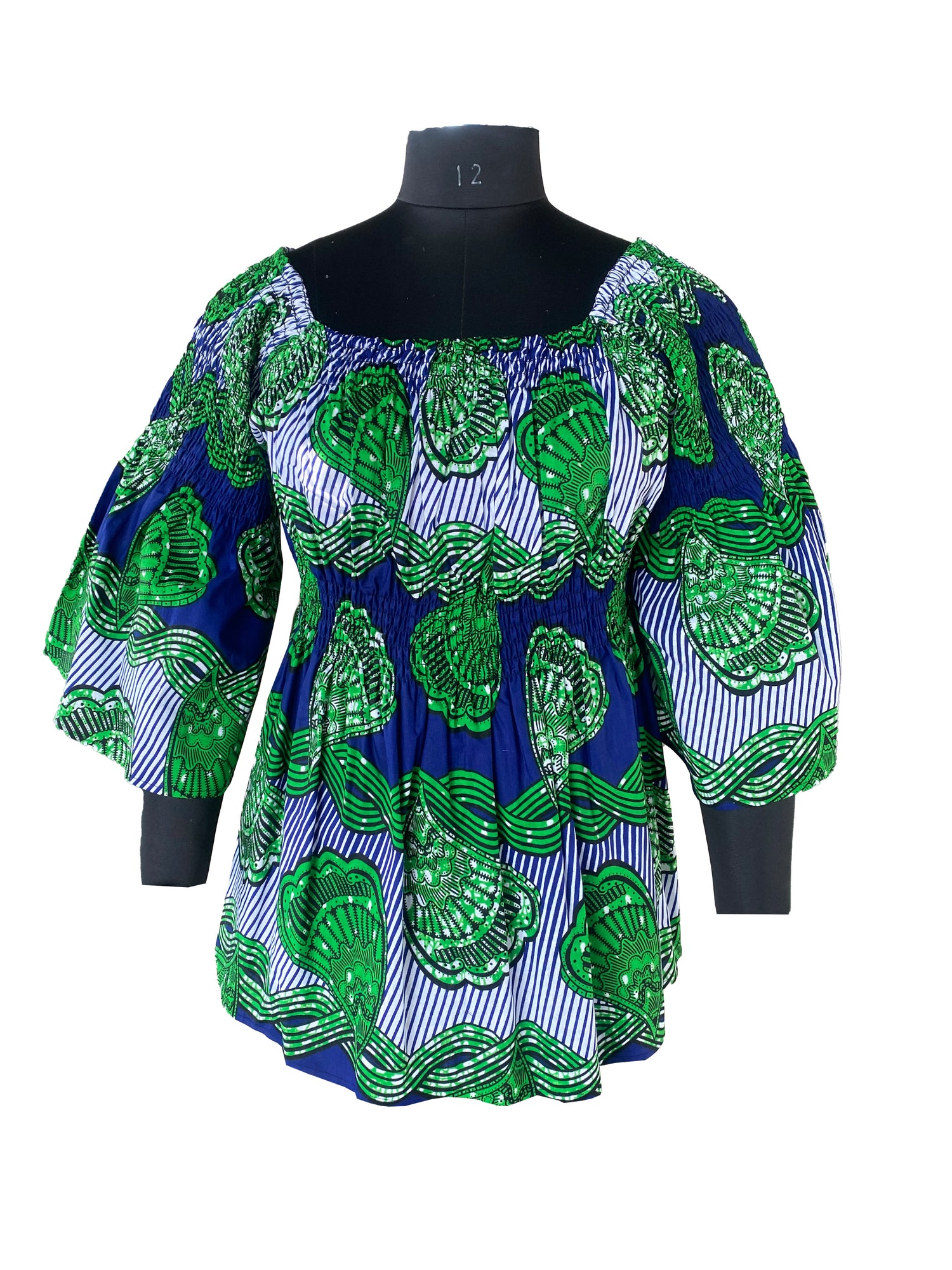 Woman wearing African smocked peplum blouse with 3/4 sleeves in Ankara print