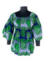 Woman wearing African smocked peplum blouse with 3/4 sleeves in Ankara print