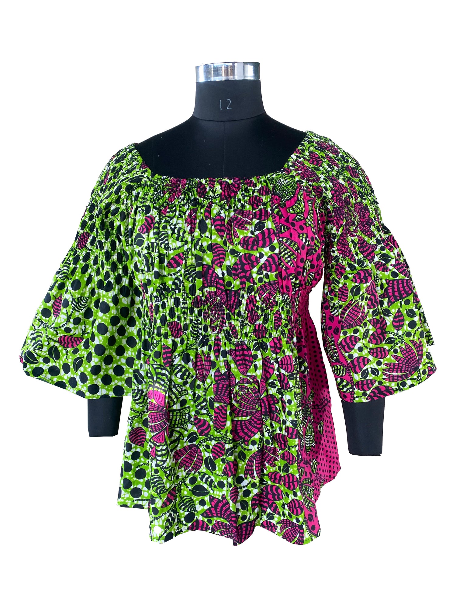 Woman wearing African smocked peplum blouse with 3/4 sleeves in Ankara print