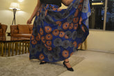 Woman wearing African print long maxi skirt in bold Ankara fabric, styled for cultural events, weddings, or everyday elegance.