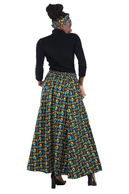 Woman wearing African print long maxi skirt in bold Ankara fabric, styled for cultural events, weddings, or everyday elegance.
