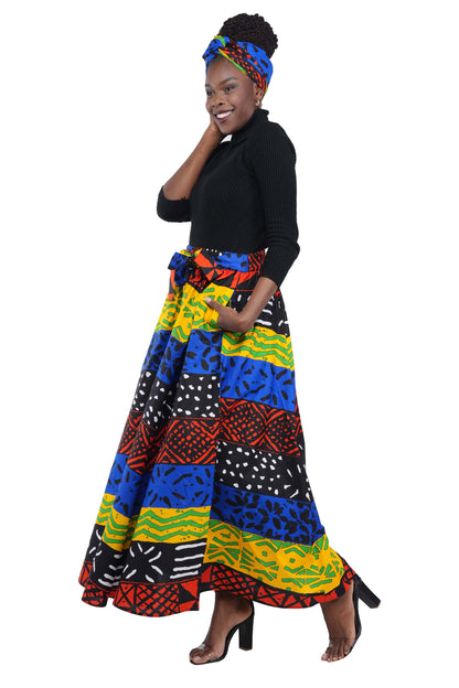 Woman wearing African print long maxi skirt in bold Ankara fabric, styled for cultural events, weddings, or everyday elegance.