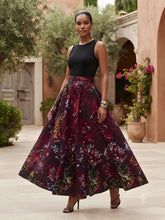 Model wearing African print maxi skirt with matching headwrap styled with a coordinating top