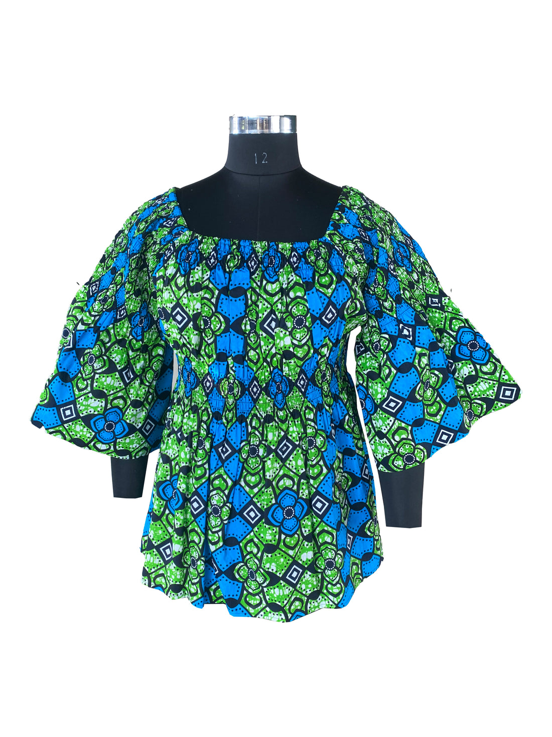 Woman wearing African smocked peplum blouse with 3/4 sleeves in Ankara print
