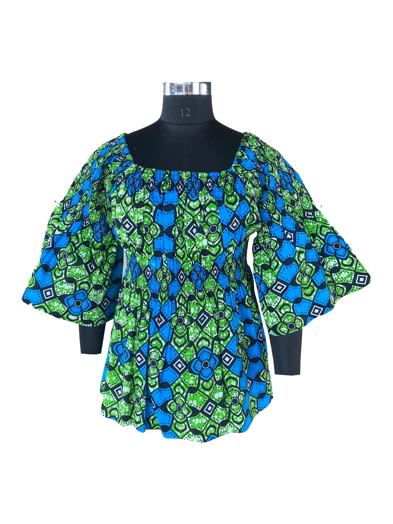 Woman wearing African smocked peplum blouse with 3/4 sleeves in Ankara print