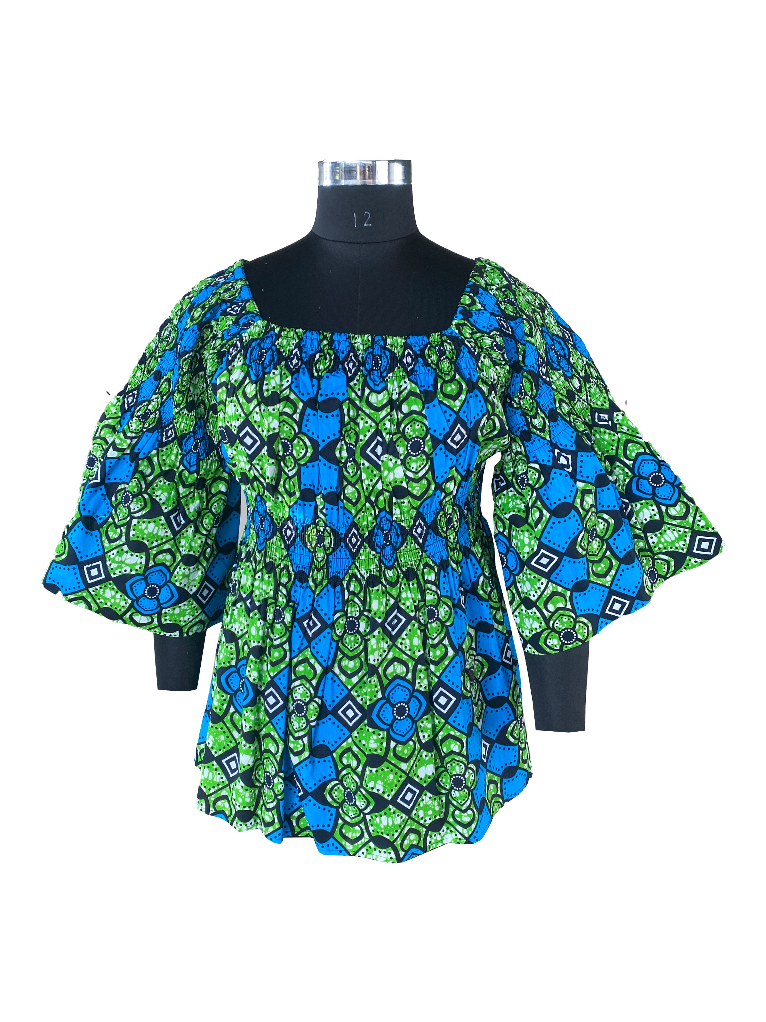 Woman wearing African smocked peplum blouse with 3/4 sleeves in Ankara print