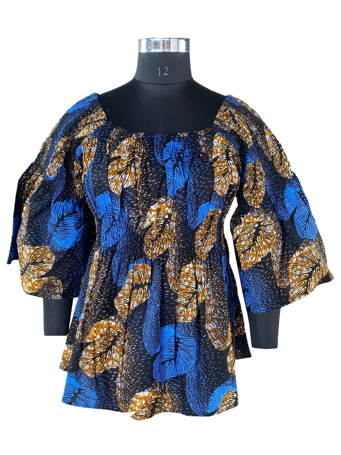 Woman wearing African smocked peplum blouse with 3/4 sleeves in Ankara print