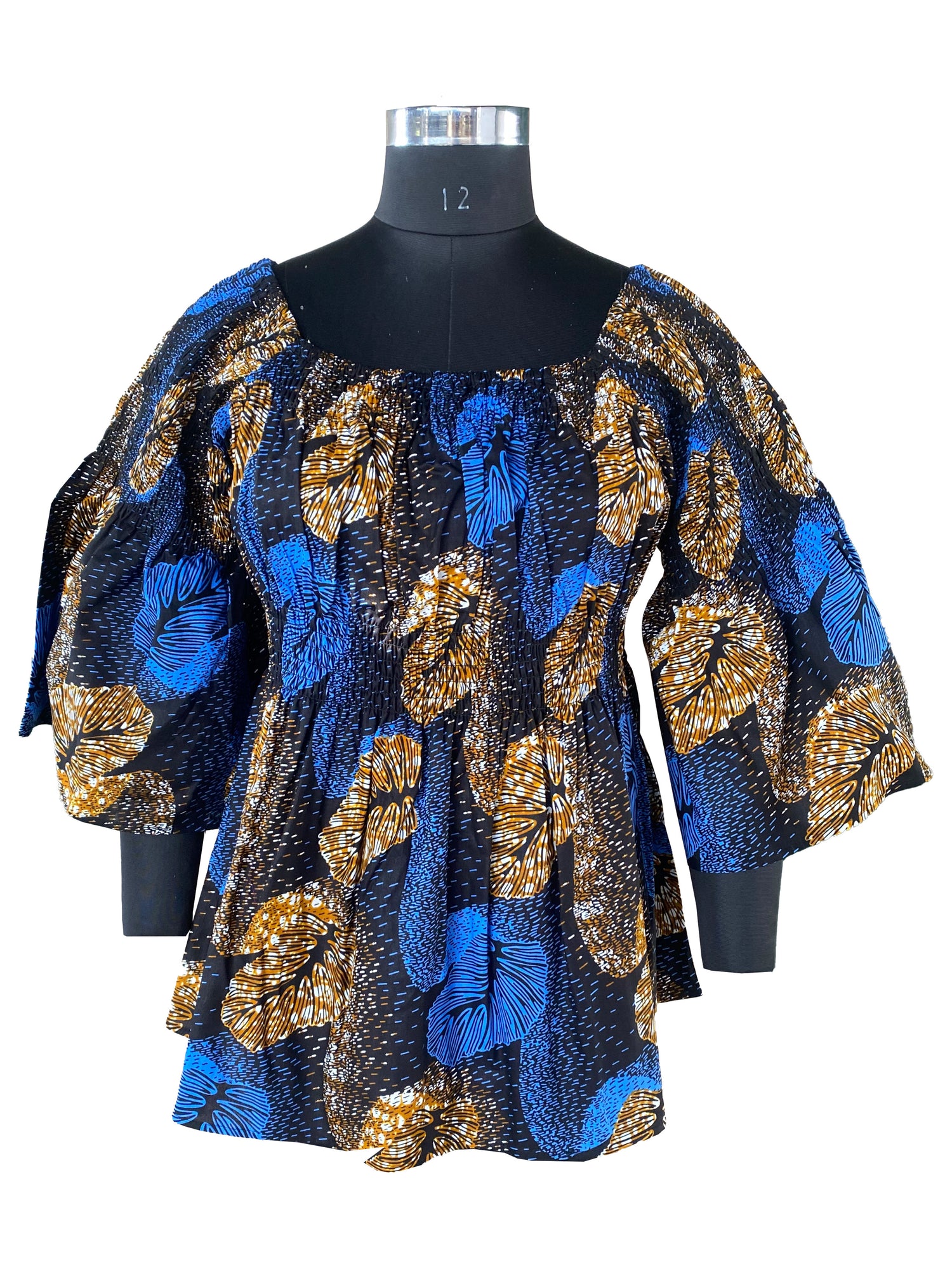 Woman wearing African smocked peplum blouse with 3/4 sleeves in Ankara print