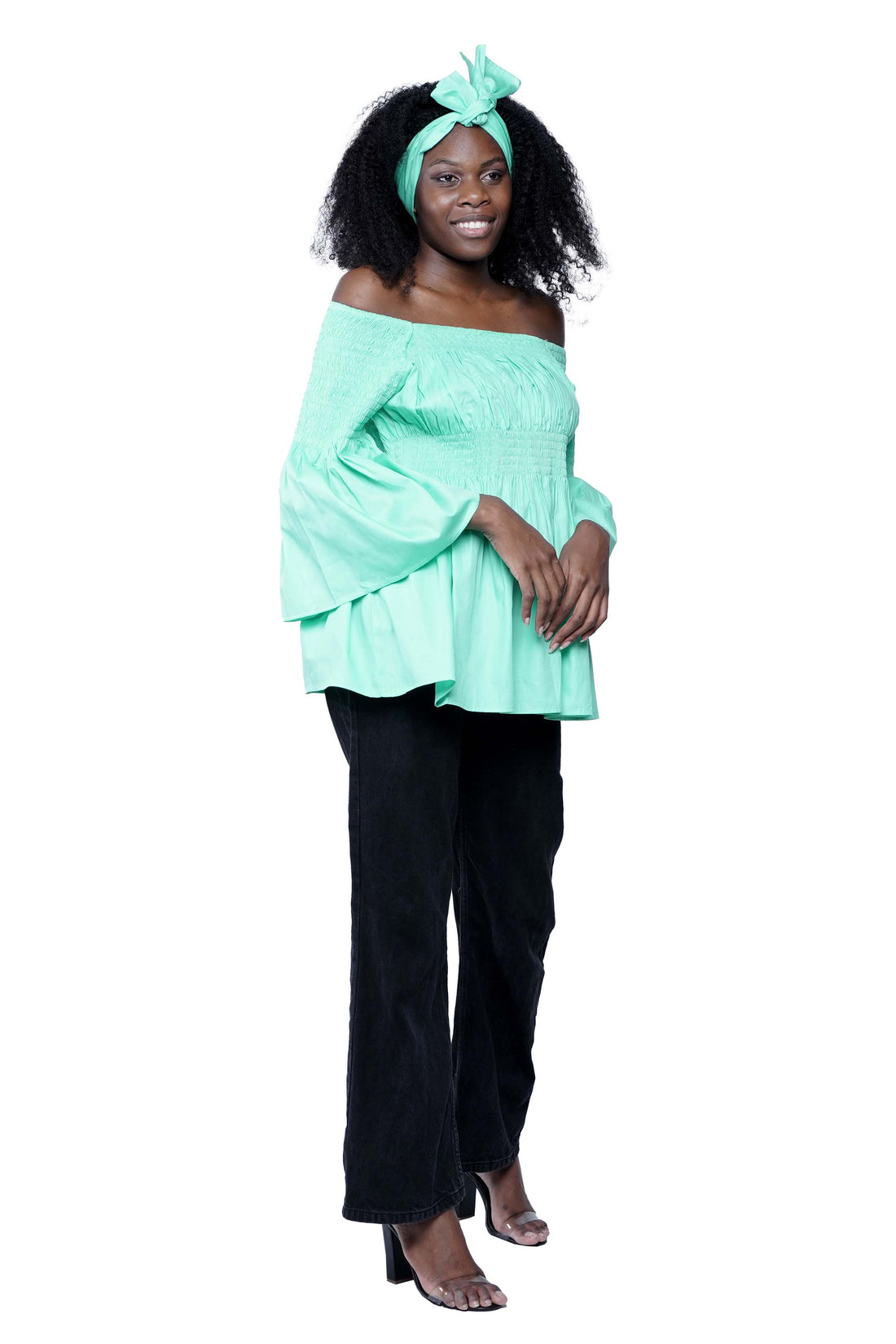 Woman wearing African smocked peplum blouse with 3/4 sleeves in Ankara print