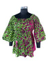 Woman wearing African smocked peplum blouse with 3/4 sleeves in Ankara print