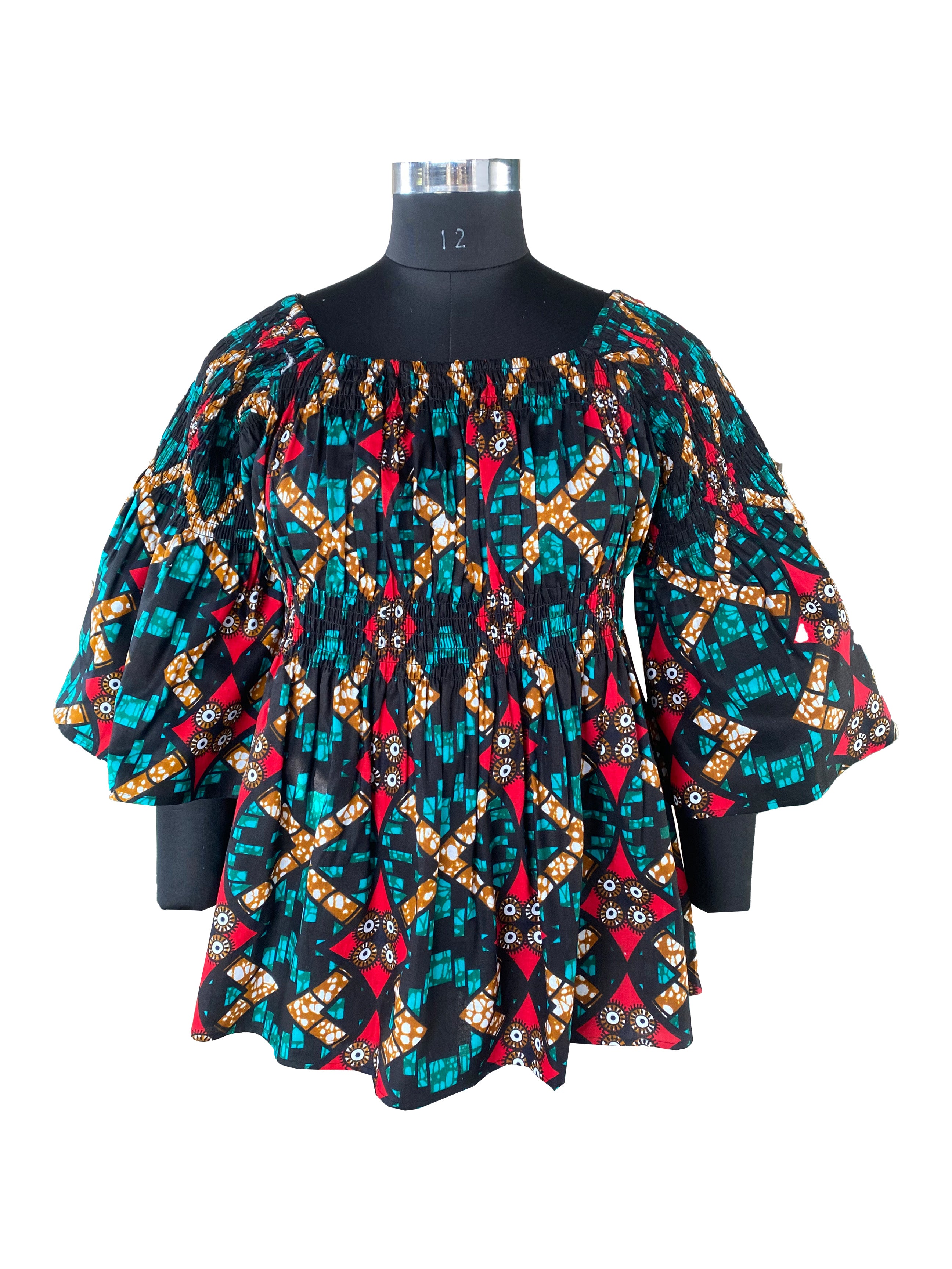 Woman wearing African smocked peplum blouse with 3/4 sleeves in Ankara print